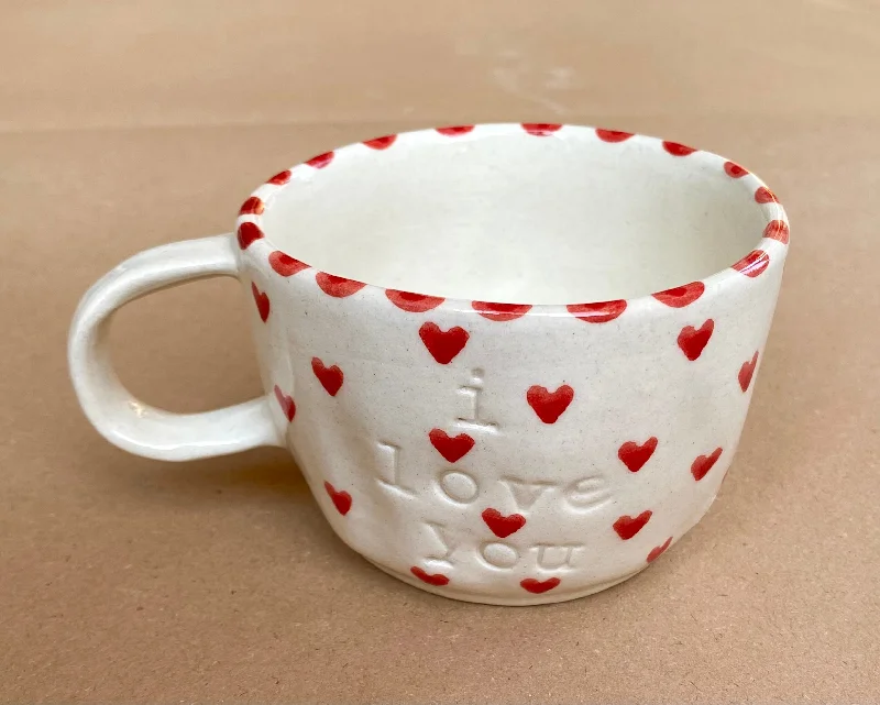 Wide base stability cup-I love you wobbly mug with tiny red hearts.